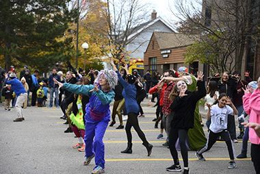 Costumed party-goers dance outside at the Kenwood Thriller Halloween party in 2017