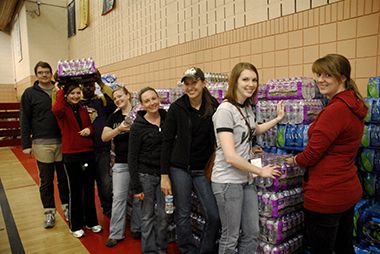 Tornado Recovery Volunteers Stacking Water Bottles