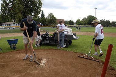 Minnesota Twins Volunteers Tending to a Baseball Diamond