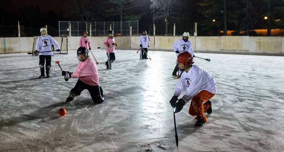 Women's broomball at night at McRae Park