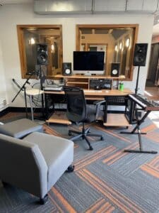 Music studio at Powderhorn Park with music keyboard, speakers, and mixing equipment.