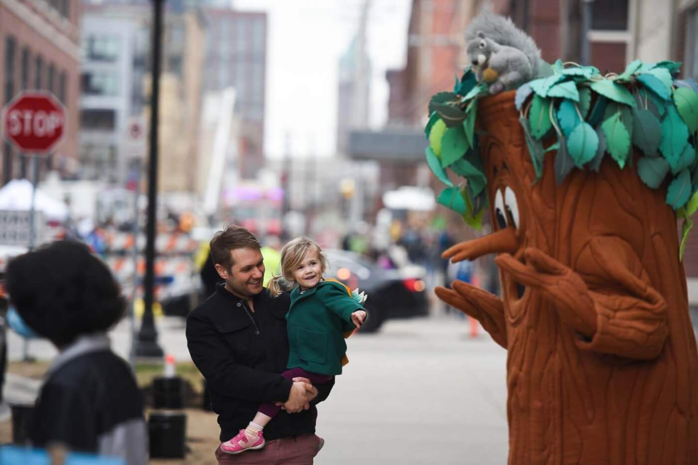 MPRB Forestry mascot Elmer the Elm Tree greets a child at the 2022 Minneapolis Arbor Day Celebration