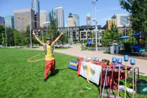 Busking performer with hula hoop at The Commons