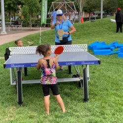 Child and MPRB Staff Playing Ping Pong in the Park