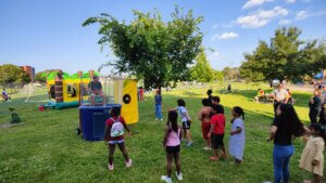 Kids playing at a dunk tank during the kickoff party.