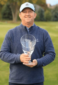 Erik Toftner holding a trophy.
