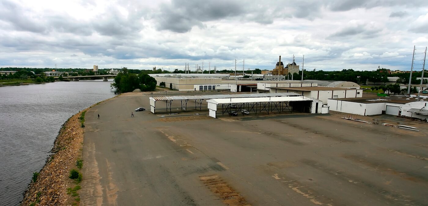 The Scherer Bros Lumber Co property in June 2010. A vast asphalt lot with industrial buildings along the Mississippi River