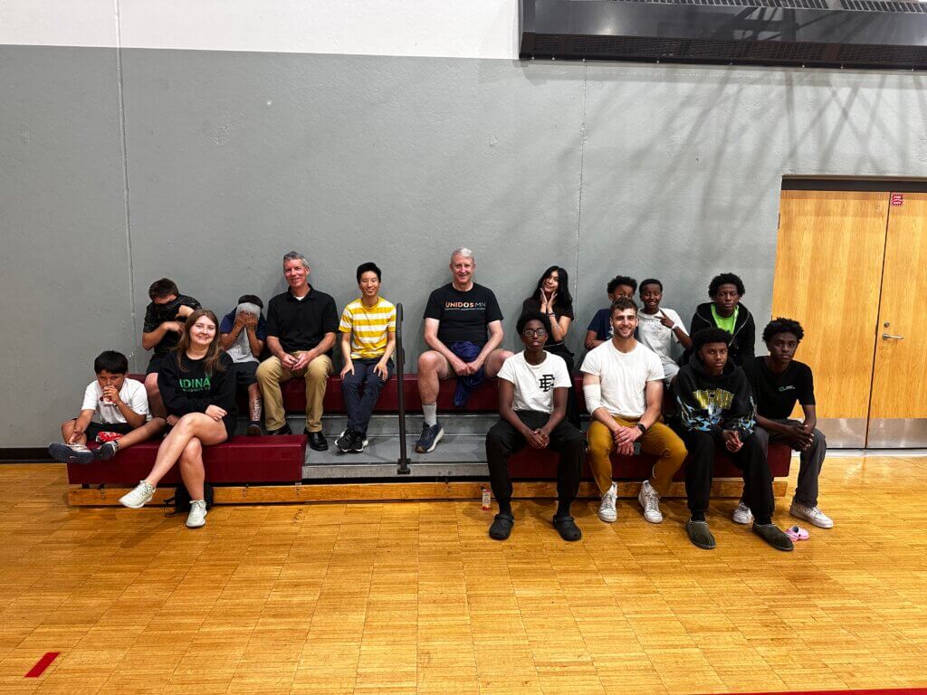 Parkside Pathways participants seated on a bleachers.