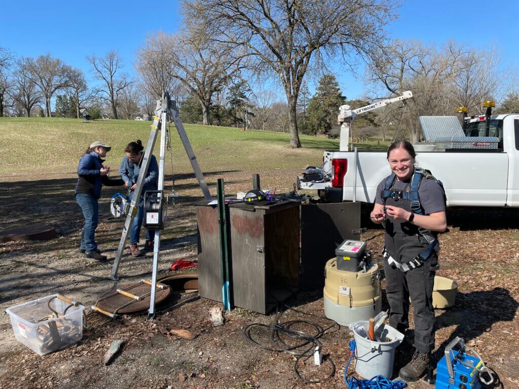 workers gathered around testing equipment