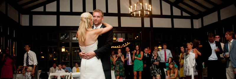 bride and groom dance at a wedding reception inside Columbia Manor