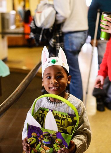 kid wearing bunny ears at Easter Egg hunt event