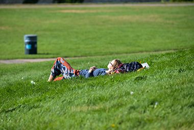 person relaxing on grass at East River Flats Park