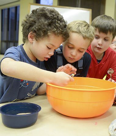 Bakers Dozen Youth Cooking Class Mixing Ingredients in Large Bowl