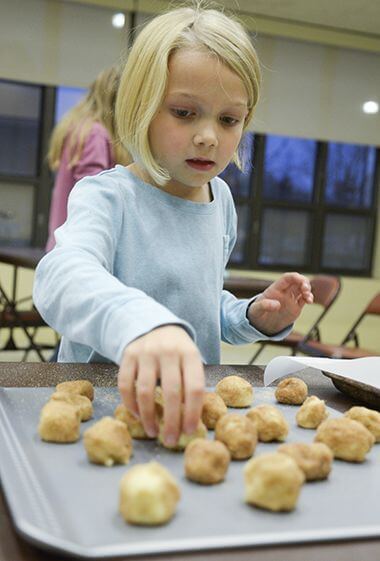 Bakers Dozen Youth Cooking Participant Lining Up Cookies on Pan