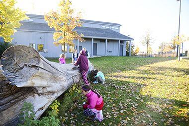 Kids Investigating a Log at Naturalist Class