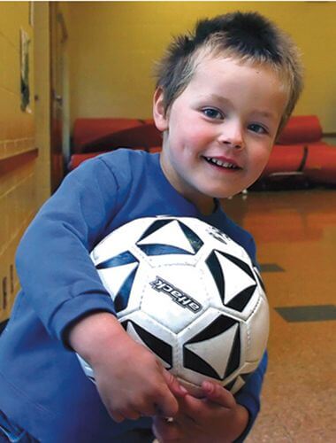 boy holding a soccer ball