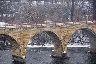 Stone Arch Bridge Covered in Snow