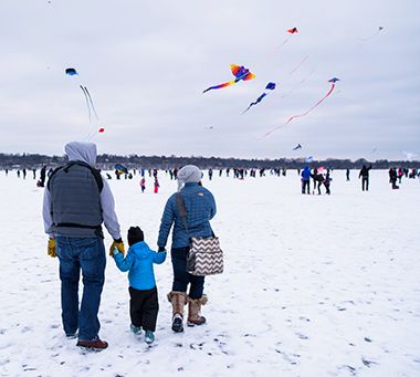 Family Watching Kites at Lake Harriet Winter Kite Festival