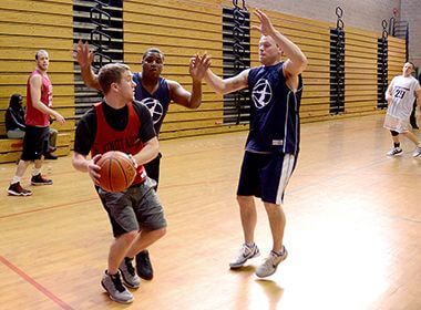 3 Men Playing Basketball at Central Gym