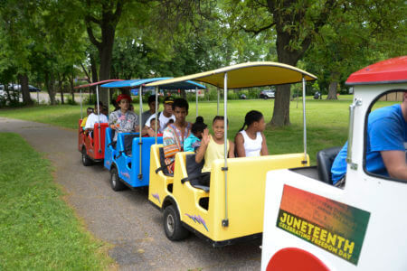 Kids in a trolley trailer during 2019 Juneteenth Celebrating Freedom Day