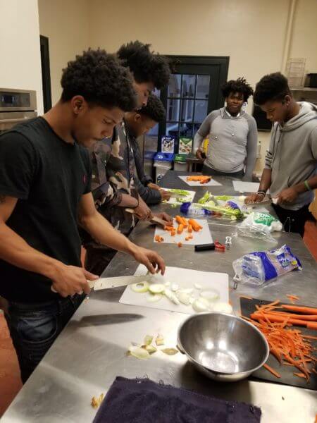Teen Teamworks members at cooking lessons.