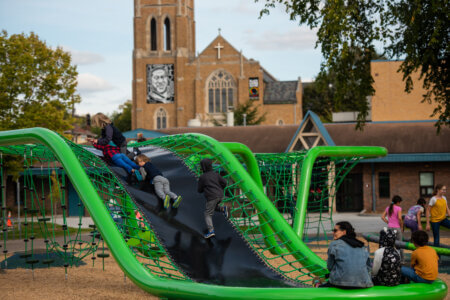 Children play on the newly opened Phelps playground in South Minneapolis