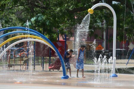 Photo of the newly opened restroom building and splash pad at Currie Park.