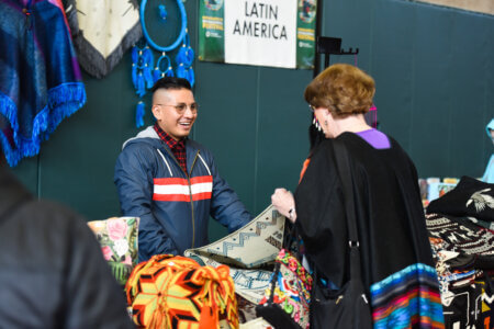 Vendor at Latin America Booth with Visitor at Minneapolis International Festival