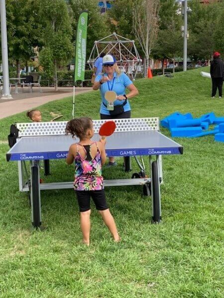 Child and MPRB Staff Playing Ping Pong in the Park